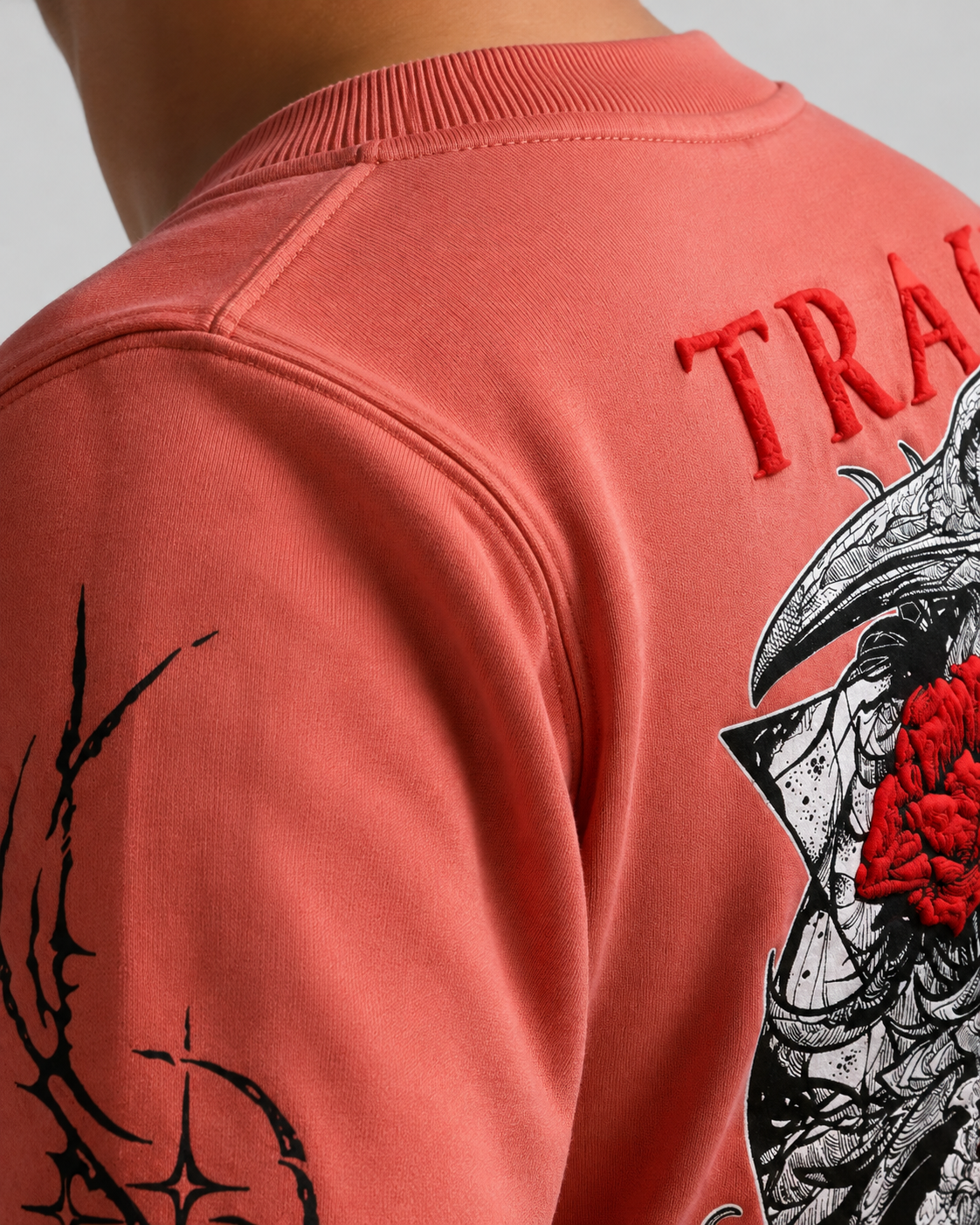 Tragic Bloom full-sleeve tee in dusty rose — print detail, raised TRAGIC lettering above the skull graphic.