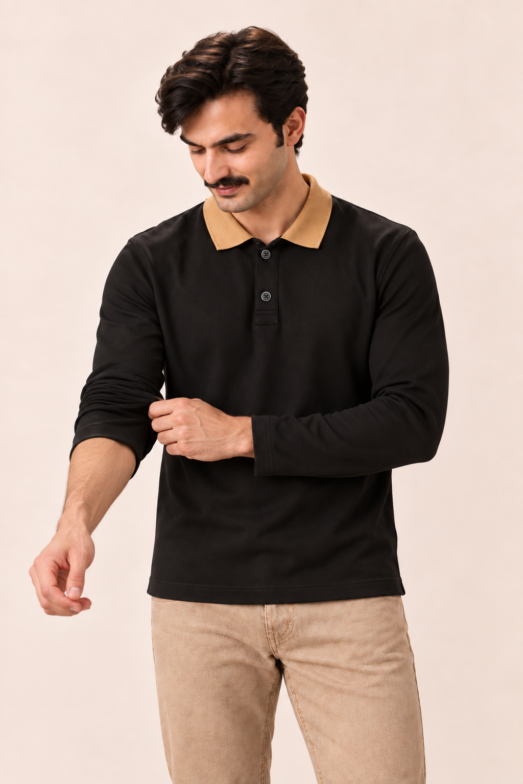 Full Sleeve Oxford Polo in Black — on model, adjusting sleeve