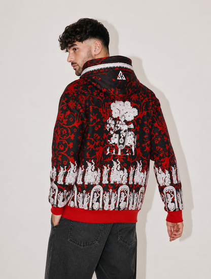A man wearing a black and red patterned hooded sweatshirt with white graphic prints, shown from the back against a plain light background.