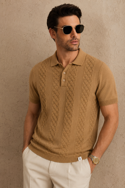 CORD knit polo in camel — front view on model against a plaster wall, styled with stone trousers