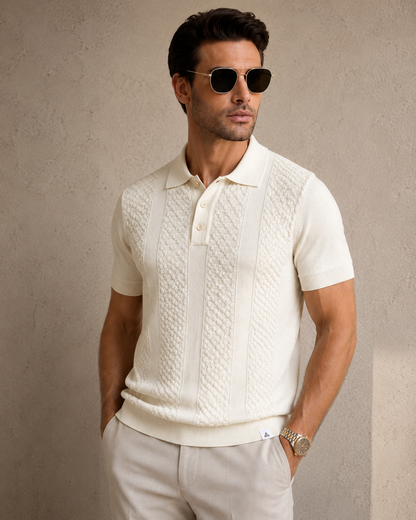 CORD knit polo in cream — front view on model against a plaster wall, styled with stone trousers