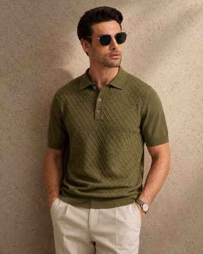 HIVE Knit Polo in olive — on model with both hands in pockets, warm shadow falling across the wall