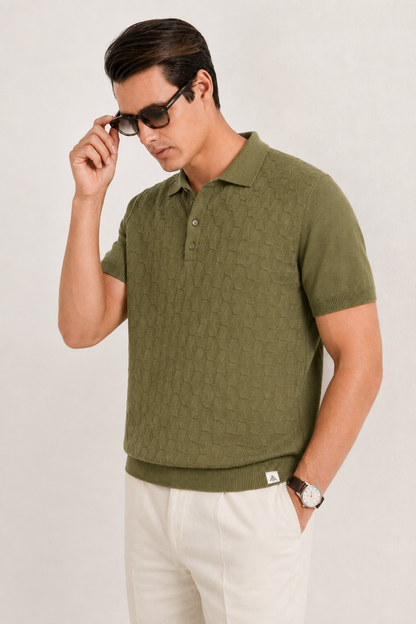LEAF Knit Polo in olive — front view on model lowering his sunglasses, worn with cream trousers