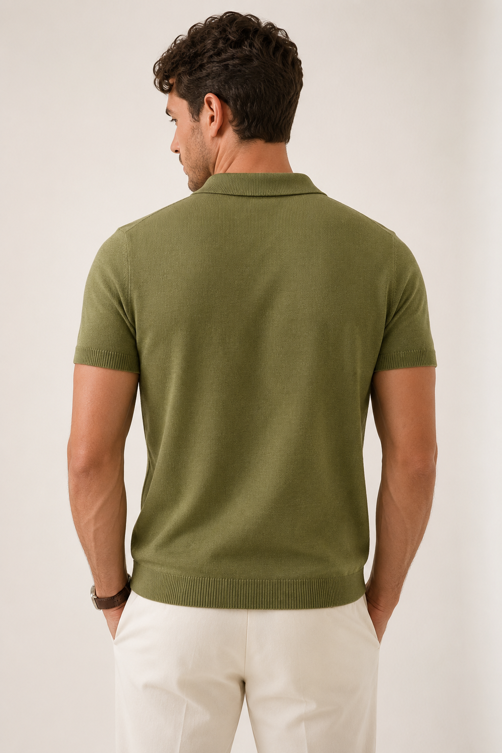 LEAF Knit Polo in olive — back view on model, plain-knit back and ribbed hem, head turned to the side