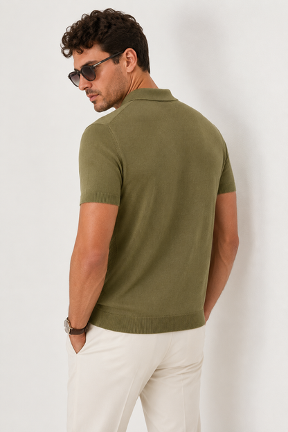 LEAF Knit Polo in olive — three-quarter back view on model, head in profile, hands in trouser pockets