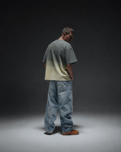 Ombrix tee in olive fading to sage — three-quarter back view on model, gradient running down the body