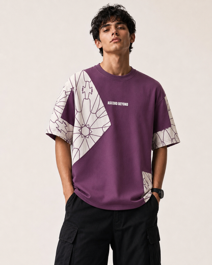 A man wearing a purple and white geometric print t-shirt with 'ASCEND BEYOND' printed on the chest, paired with black cargo pants, against a plain beige background.
