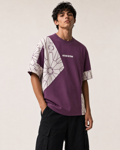 A man wearing a purple and white geometric patterned t-shirt with 'ACCELSOR RETIRING' printed on the chest, paired with black cargo pants, against a plain light beige background.