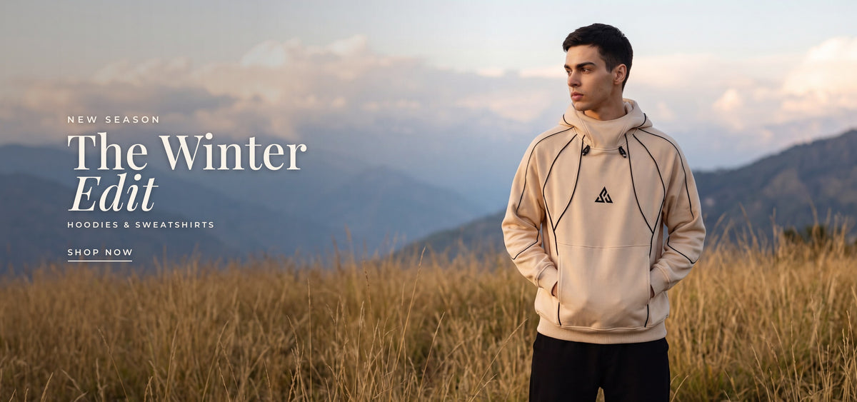 New season: The Winter Edit, hoodies and sweatshirts. A man in the sand FUSION hoodie in a golden mountain meadow. Shop winterwear.