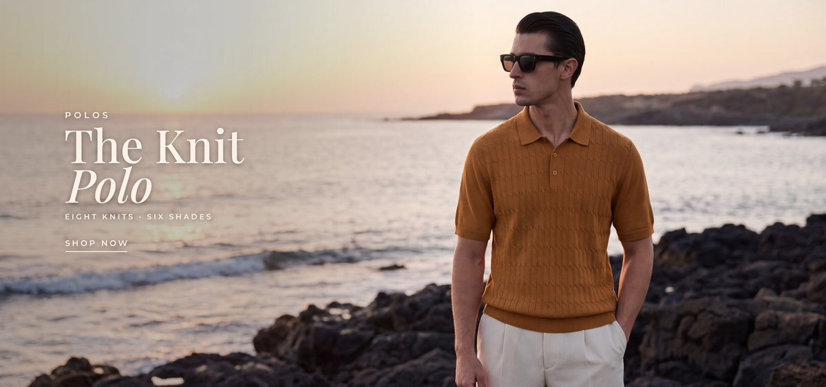 Polos: The Knit Polo, eight knits in six shades. A man in the camel CANE knit polo and black sunglasses on a rocky coastline at sunset. Shop polos.