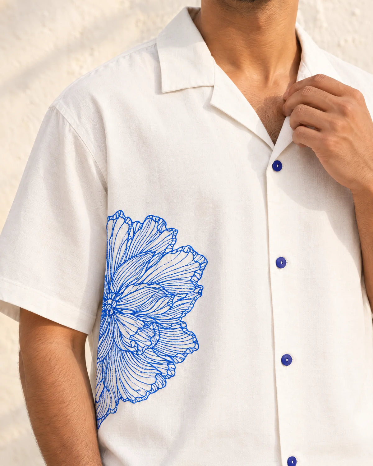 Close-up of the Vinelet chest embroidery and cobalt buttons on the body