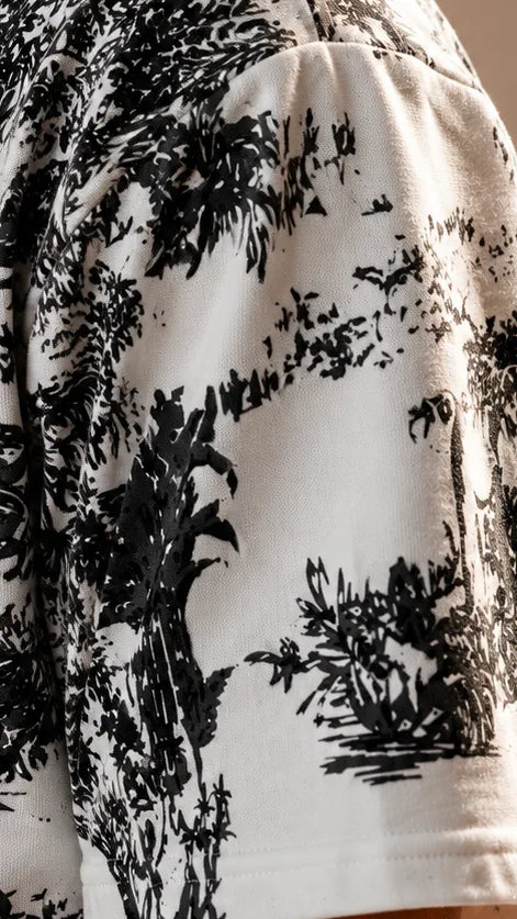 The black forest toile print on the short sleeve of the off-white ARANYA half-zip hoodie