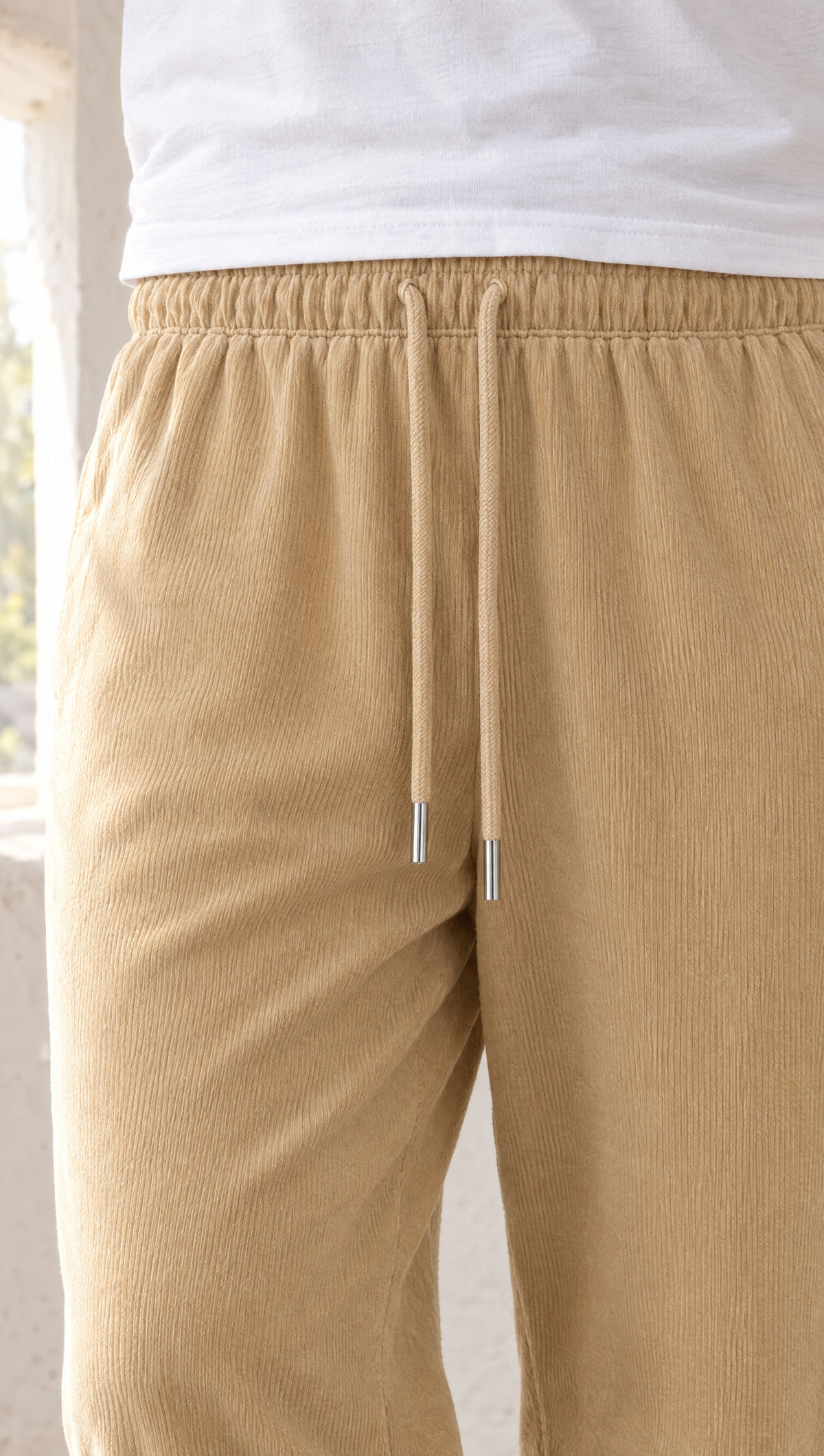 The shirred elastic waist of the KSHEER joggers in sand beige, with a tonal drawcord and metal tips