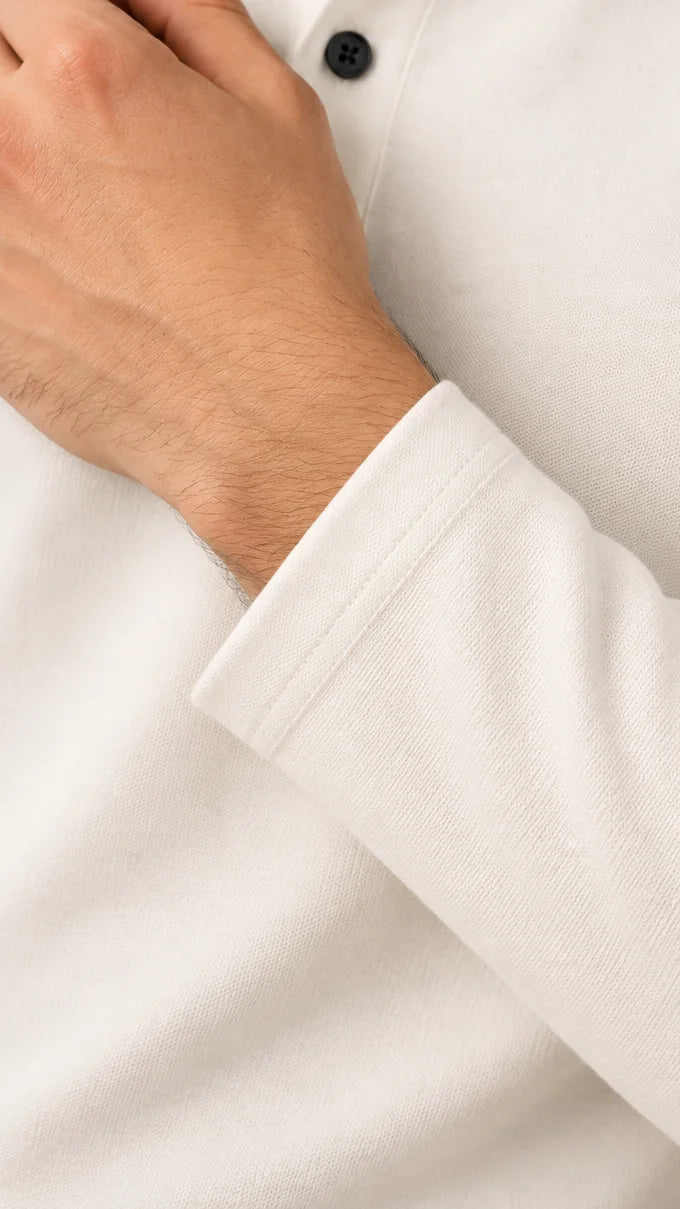 Close-up of the clean hemmed cuff and oxford weave on the cream Full Sleeve Oxford Polo