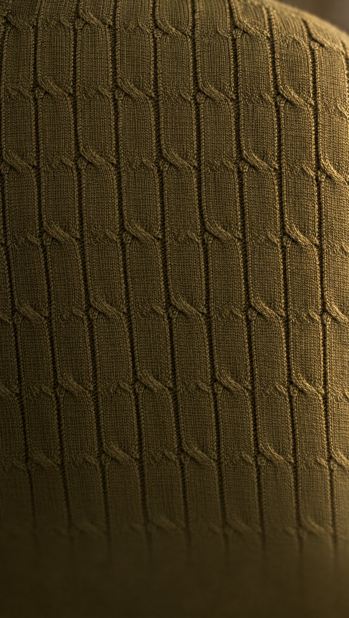 Close-up of the olive CANE knit: narrow vertical ribs knotted at intervals