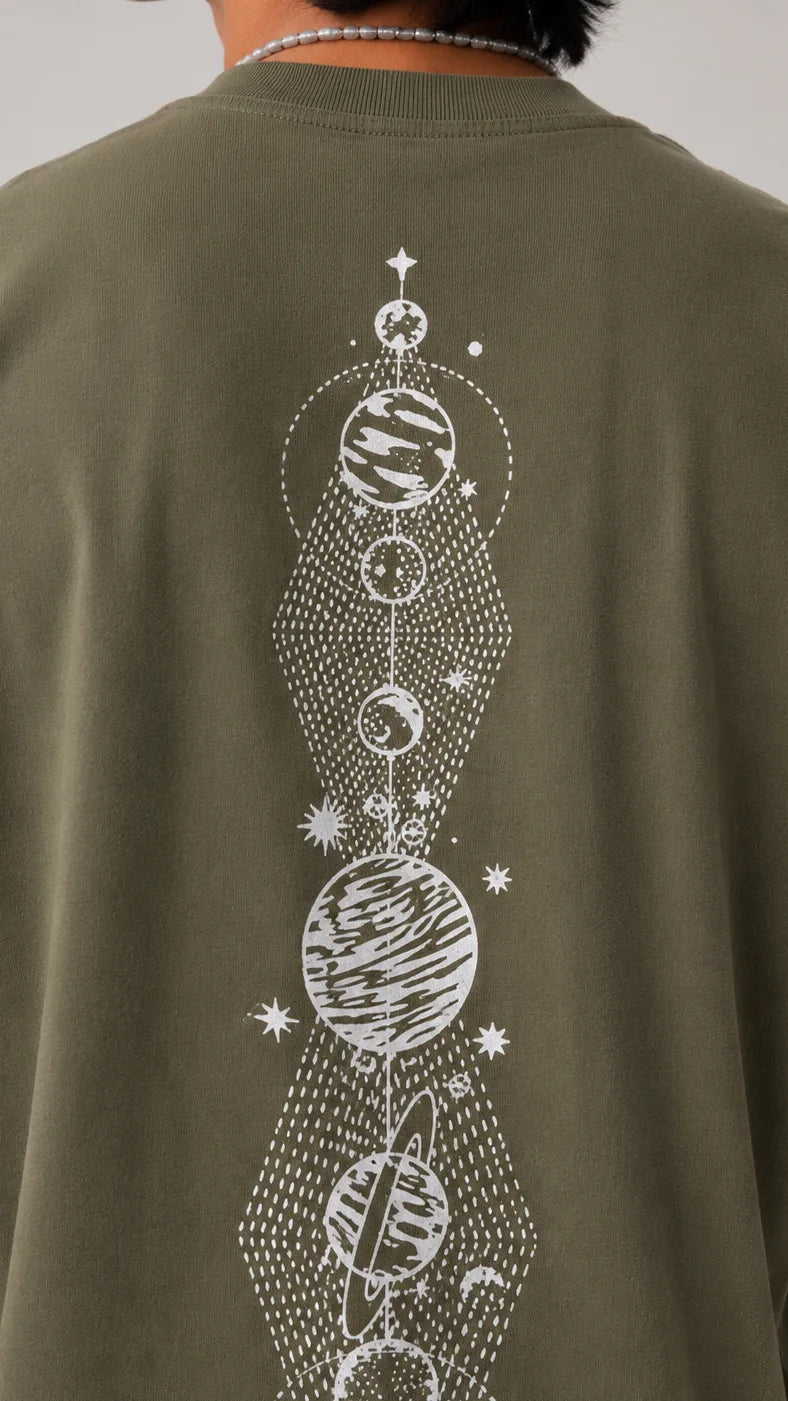 Close-up of a column of white line-art planets down the back of an olive sleeveless tee