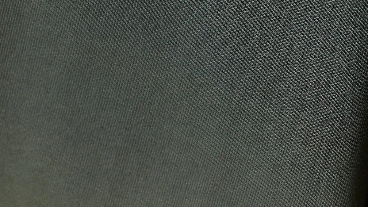Edge-to-edge close-up of olive French Terry cotton knit