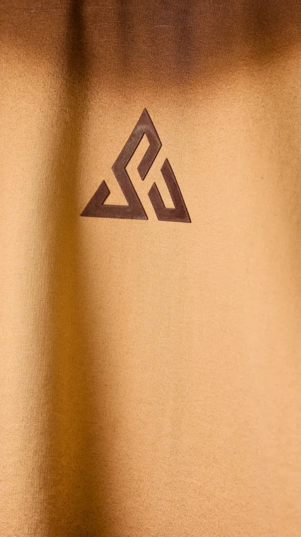 Close-up of the deep-brown Sunya triangle on sand-coloured cotton